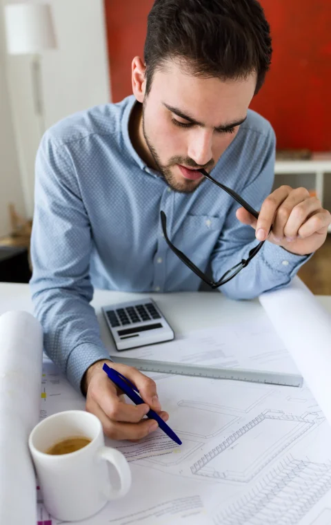 handsome-young-businessman-working-office handsome-young-businessman-working-office